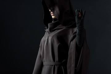 cropped view of woman in death costume holding dice isolated on black