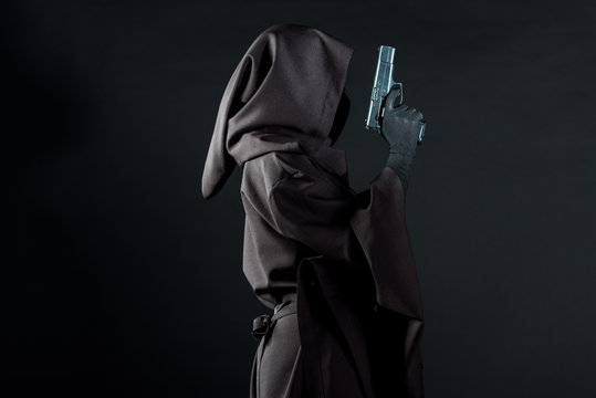 Side View Of Woman In Death Costume Holding Gun Isolated On Black