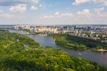 Urban aerial view photo from drone of coastline, skyline and cityscape of Dnieper River near Rusanivka island at summer time. (Kyiv, Kiev) Ukraine.