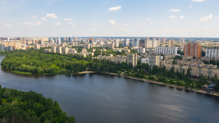 Aerial top view from drone on cityscape, skyline and coastline of Dnieper River near Rusanivka island at summer time. (Kyiv, Kiev) Ukraine.