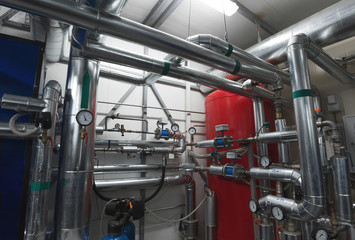 Boiler room. Water treatment pipes and pressure gauges installed for pressure control. Expansion Tank. Ventilation System