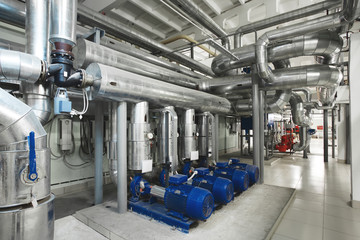boiler room with pumps and pipe lines supplying steam with pressure gauges installed