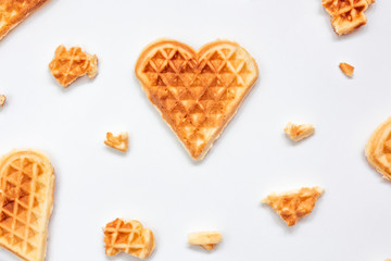 Sweet meal background. Design with Heart shaped waffles on white background. Love food concept.