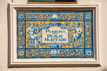 Indicative sign of square name made by colored tiles in Caceres
