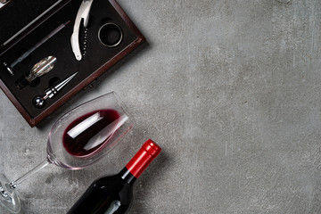 Accessories for oenology. Cup with wine on concrete background. Copy Space.