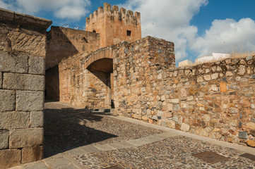 Alley with a gateway in an old stone wall at Caceres.