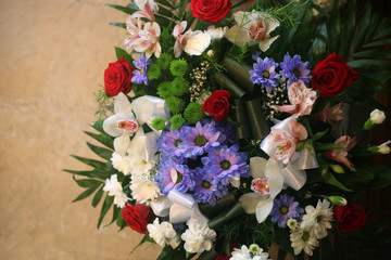 Big bouquet of colorful different flowers top view against orange stone background