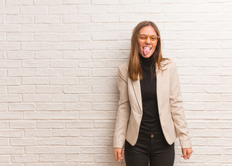 Young pretty business entrepreneur woman funnny and friendly showing tongue