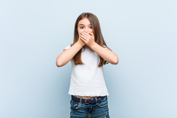 Cute girl shocked covering mouth with hands.
