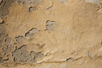 Close-up of plaster peeling off an old wall forming a quaint background at Caceres