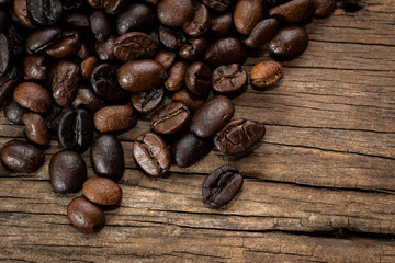 Roasted coffee beans on old wooden floors