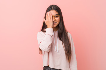 Young pretty arab woman wearing a casual sport look having fun covering half of face with palm.