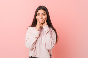 Young pretty arab woman wearing a casual sport look doubting between two options.