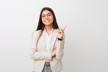 Young business arab woman isolated against a white background smiling cheerfully pointing with forefinger away.