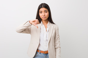 Young business arab woman isolated against a white background showing a dislike gesture, thumbs down. Disagreement concept.