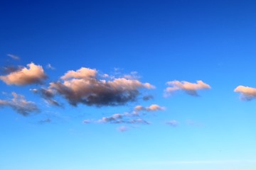 Calm and beautiful mixed fluffy cloud formations on a stunning deep blue sky