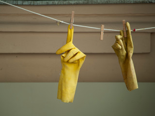rubber gloves hanging on a clothesline
