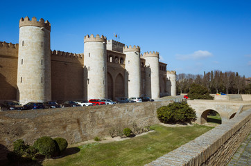 Fototapeta na wymiar Zaragoza, Aragon, Spain - February 14th, 2019 : Walls and moat of the Aljafería Palace Unesco World Heritage Site.
