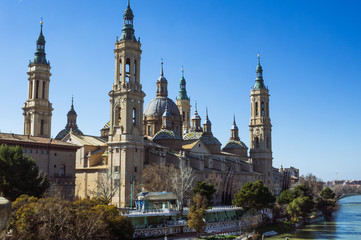 Fototapeta na wymiar Zaragoza, Aragon, Spain - February 14th, 2019 : Basilica of Our Lady of the Pillar by the river Ebro. It is reputed to be the first church dedicated to Mary in history.