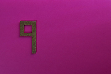 gold number nine on pink background