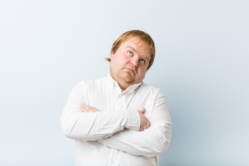 Young authentic redhead fat man tired of a repetitive task.