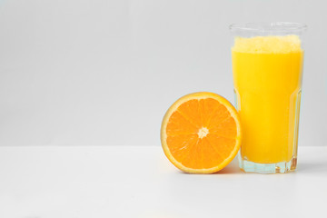 Fresh orange juice on blue background