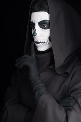 woman with skull makeup showing hush sign isolated on black