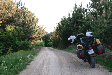 tourist motorcycle with side bags. enduro advetnture, space for text, summer day. Adventure expedition, explore, dirt road, offroad.