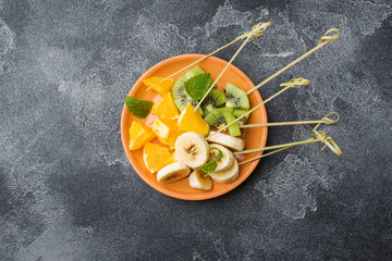 Fresh fruit on skewers for fondue. Table for summer party Copy space