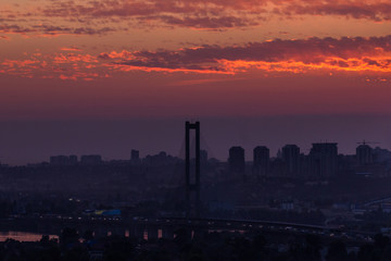 Fototapeta na wymiar Big bridge in the city at sunset