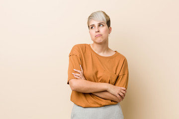 Obraz premium Young plus size woman with short hair tired of a repetitive task.