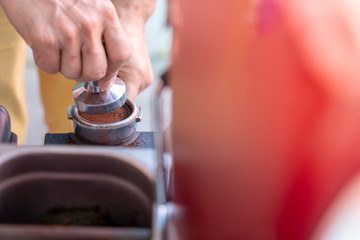 Barista are holding Cup of fresh coffee powder.