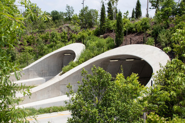 Attractive tunnels over highway in Tulsa Oklahoma near park and Arkansas River with many young...