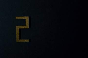 gold number two on dark background