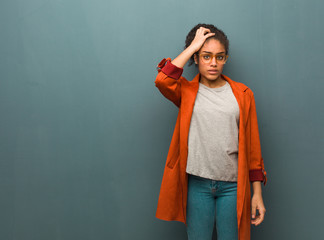 Young black african american girl with blue eyes worried and overwhelmed