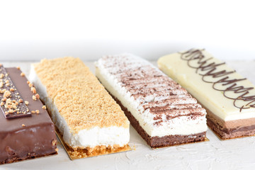 Beautiful Delicious dessert cheesecakes and chocolate cake. Group of four different types of sweet for holiday Shavuot.