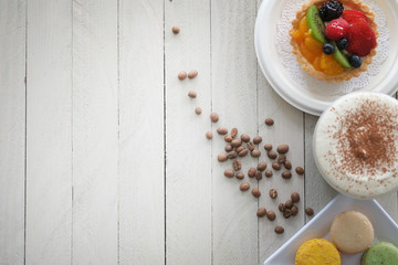 Desert  fruit tart and pastries  with coffee on wood table.