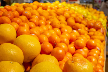 Several varieties of citrus fruit on display at the grocery store