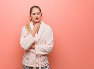 Young russian woman wearing pajama coughing, sick due a virus or infection