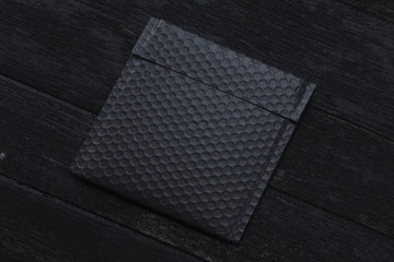 Black packet on black background. 3d rendering. copy space. Empty space.