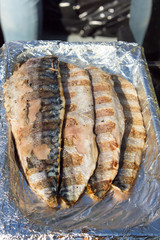 Grilled fish, fillet is served on foil.