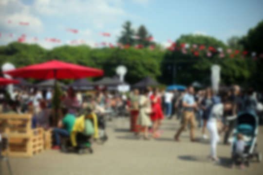 Defocused background of people in park food festival, summer festival, sunny day