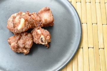 fried fermenting pork bone with garlic on plate