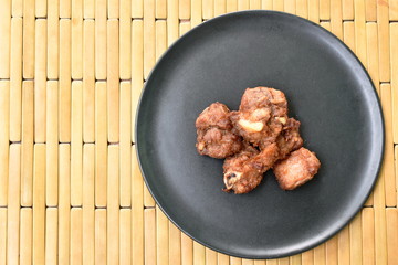 fried fermenting pork bone with garlic on plate