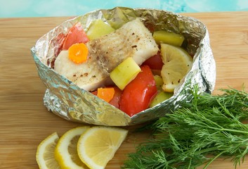 Baked fish with vegetables and herbs