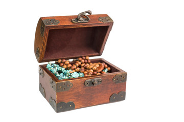 Wooden vintage box for jewelry on a white background. In a box there is a blue and wooden necklace