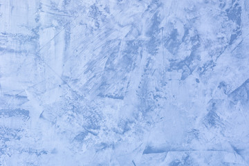 Abstract blue background. Texture of uneven plastered wall. Putty with stains and roughness. The...