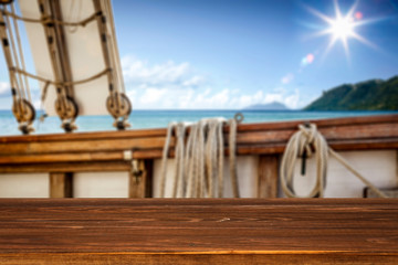 Desk of free space and ship background with ocean 