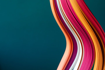 Abstract green background with orange, burgundy and white stripes.