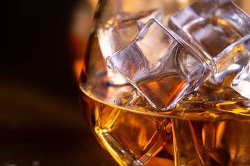 Naklejka na ściany i meble a glass of whiskey on wooden table